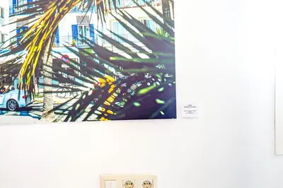 a picture of a palm tree hanging on a wall at The Beach House Paradise by Hello Homes Sitges in Sitges