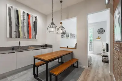 a kitchen with a wooden table and a sink at Art House Fira Apartments in Barcelona