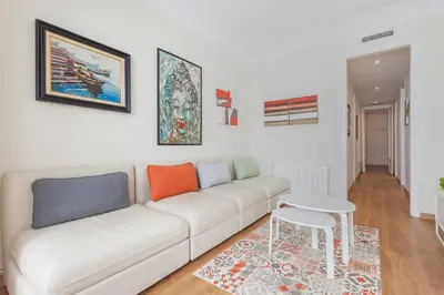 a living room with a white couch and a table at Art House Fira Apartments in Barcelona