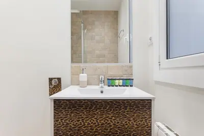 a bathroom with a sink and a mirror at Art House Fira Apartments in Barcelona