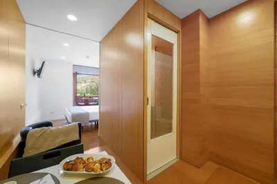 a room with wooden walls and a table with a bowl of food at Abarco Apartments in Santa Coloma