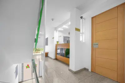 a hallway with a wooden door in a building at Abarco Apartments in Santa Coloma