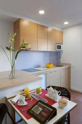 a kitchen with a table with a table sidx sidx sidx sidx at Abarco Apartments in Santa Coloma