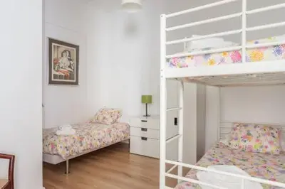 a bedroom with two bunk beds and a desk at Piso Zona Plaza España, junto a Montjuic, in Barcelona