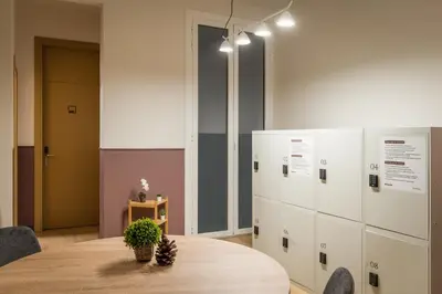a conference room with a table and some lockers at BYPILLOW Ramblas in Barcelona