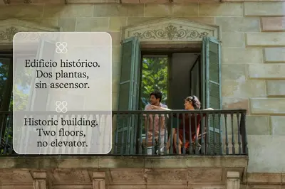 two people standing on a balcony with a sign at BYPILLOW Ramblas in Barcelona