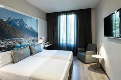 a hotel room with a bed and a tv at Catalonia Gran Via BCN in Barcelona