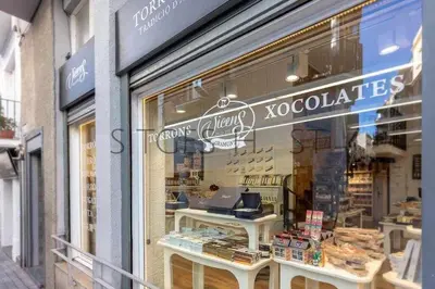 a store front window of a book store with a laptop at Sitges CENTRAL - En el corazón de Sitges in Sitges