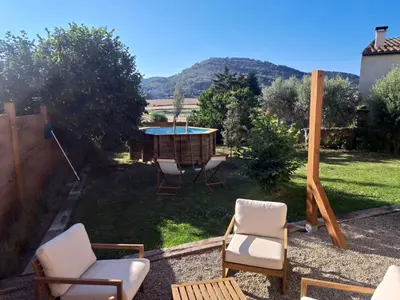 a backyard with a table and chairs and a table and a pool at Cal Puó Turismo Rural in Collsuspina