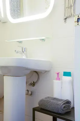 a bathroom with a sink and a mirror at Barcelona City Street Hostal in Barcelona
