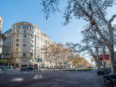 a large white building on a city street at Fewdays Barcelona Apartments in Barcelona