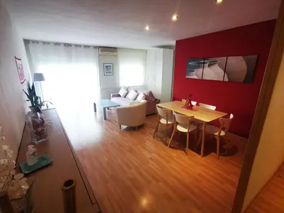 a living room with a table and a couch at Elsi's place in Premiá de Mar