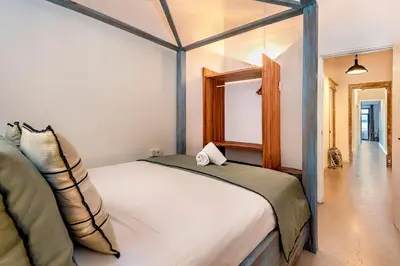 a kitchen with a wooden table and a sink at La Guarida Suites in Barcelona