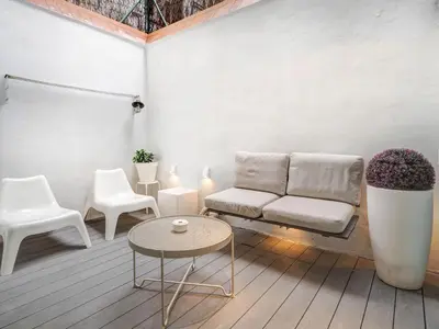 a living room with a couch and chairs and a table at White Center Apartment by Hello Homes Sitges in Sitges