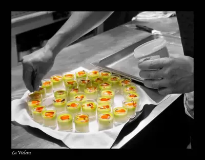 a person holding a tray of food on a table at La Violeta HOTEL SPA & CHILL OUT in Castelltersol