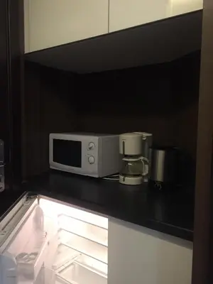 a microwave sitting on top of a kitchen counter at Barcelona Fifteen central Aparthotel in Barcelona