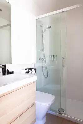a bedroom with two beds and a side table at Brummell Apartments Poble Sec in Barcelona