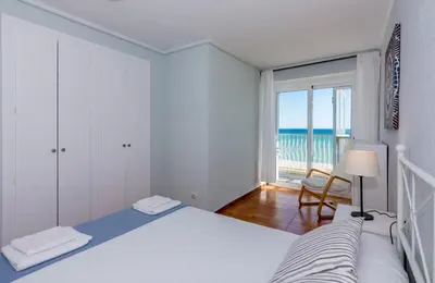 a bedroom with a bed and a view of the ocean at HomeHolidaysRentals Etoile in Calella