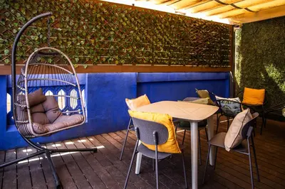a patio with a table and chairs and a swing at Urbany Hostel BCN GO! in Barcelona