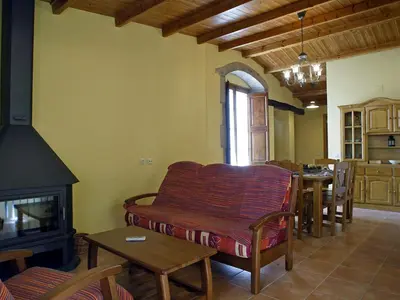 a living room with a couch and a fireplace at Mansion in Maians with Private Pool in Castellfullit del Boix