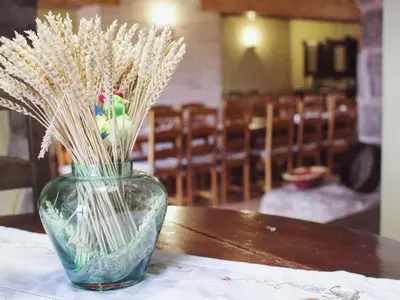 a vase filled with dried grasses sitting on a table at Mansion in Maians with Private Pool in Castellfullit del Boix