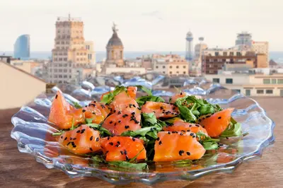 a glass bowl filled with oranges on top of a table at Hotel Royal Passeig de Gracia in Barcelona
