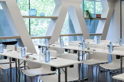 a row of tables and chairs in a room with windows at Hotel Royal Passeig de Gracia in Barcelona