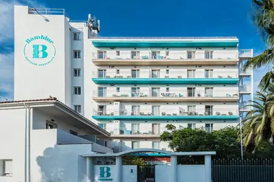 a large white building with a sign on it at Bamblue Boutique Apartments in Pineda de Mar