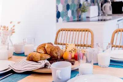a table with a plate of bread and pastries on it at Bamblue Boutique Apartments in Pineda de Mar