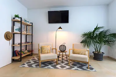 a living room with two chairs and a table at Bamblue Boutique Apartments in Pineda de Mar