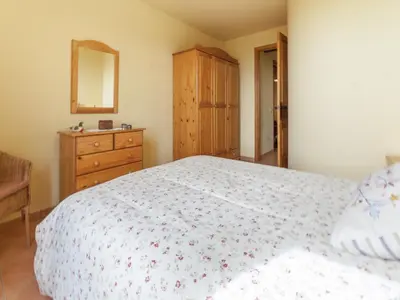 a bedroom with a bed and a dresser and a mirror at 17th century farmhouse in Bages, near Montserrat in Castellfullit del Boix