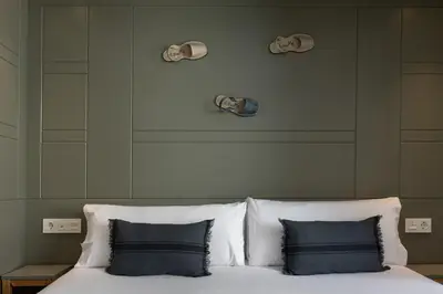 a bed with two pillows and skulls on the wall at Enjoybcn Patio de Gala in Barcelona