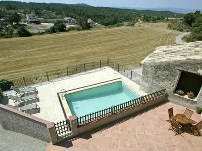 a swimming pool on top of a house with a field at Cottage in Maians with Pool and Garden in Castellfullit del Boix