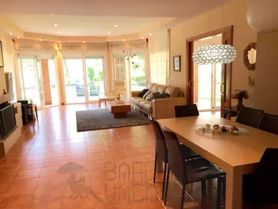 a living room with a table and a couch at BarcelonaVacances-Villa Lucia in San Pol de Mar