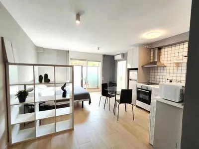 a living room with a bed and a kitchen at Mazi Apartments Suite in Mataró