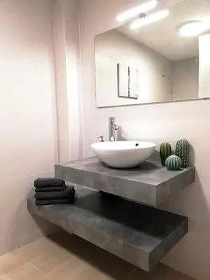 a bathroom with a sink on a counter with a mirror at Mazi Apartments Suite in Mataró