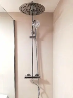 a shower in a bathroom with a shower head at Mazi Apartments Suite in Mataró