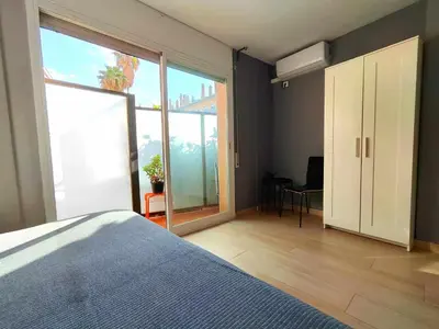 a bedroom with a bed and a large window at Mazi Apartments Suite in Mataró