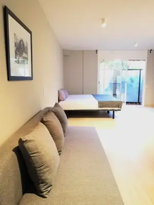 a living room with a couch and a bed at Mazi Apartments Suite in Mataró