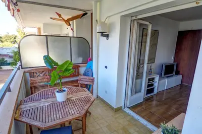 a living room with a table and a tv at Clarimar Apartment by Hello Homes Sitges in Sitges