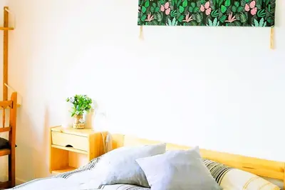 a bedroom with a bed and a table with a plant at Ca la Nena Morena - Refugio cálido con chimenea y vistas al Montseny in Vallgorguina