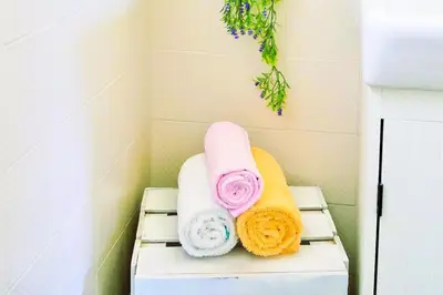 two towels sitting on a shelf in a bathroom at Ca la Nena Morena - Refugio cálido con chimenea y vistas al Montseny in Vallgorguina