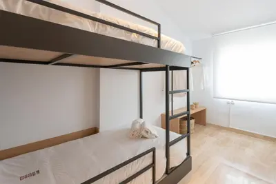 a bedroom with two bunk beds in a room at Petit Luxe Ègara in Terrassa