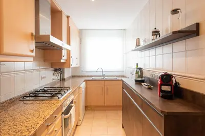a kitchen with a sink and a stove top oven at Petit Luxe Ègara in Terrassa