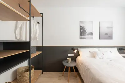 a bedroom with a bed and a small table at Petit Luxe Ègara in Terrassa