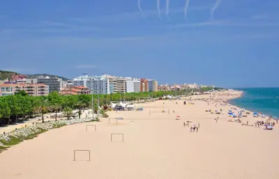 a beach with a lot of people on it at Vivalidays ilaria - Calella in Calella