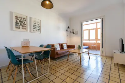 a living room with a table and chairs and a couch at EG42B - Piso modernista 6 pax con WIFI en centro Barcelona in Barcelona