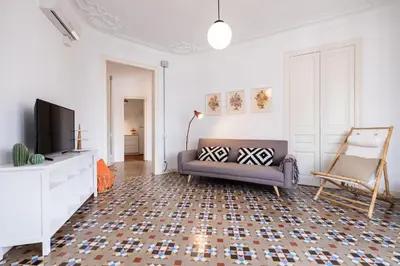 a living room with a couch and a tv at b32-Sunny and Modernist apartment for groups in center in Barcelona