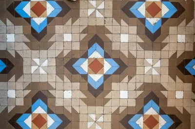 a tiled floor with blue and brown tiles at b21-Apartamento Modernista para Grupos in Barcelona