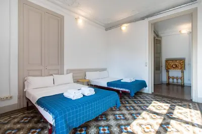 a hotel room with a bed with towels on it at b21-Apartamento Modernista para Grupos in Barcelona